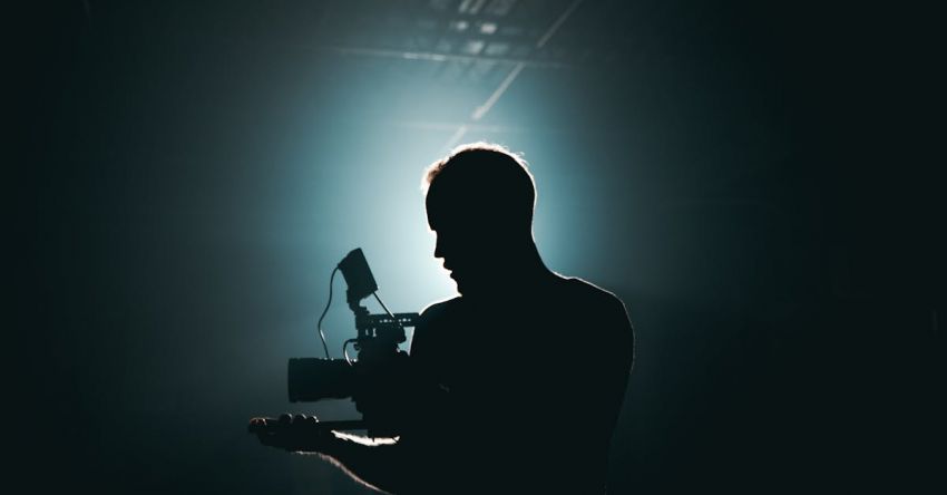 Photography Gear - Silhouette of Man Standing in Front of Microphone