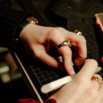 Scheduling Tools - A woman working on a piece of jewelry in a workshop
